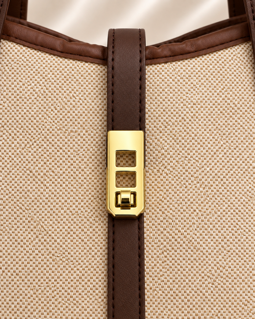 Gold clasp detail of beige and brown woven tote bag