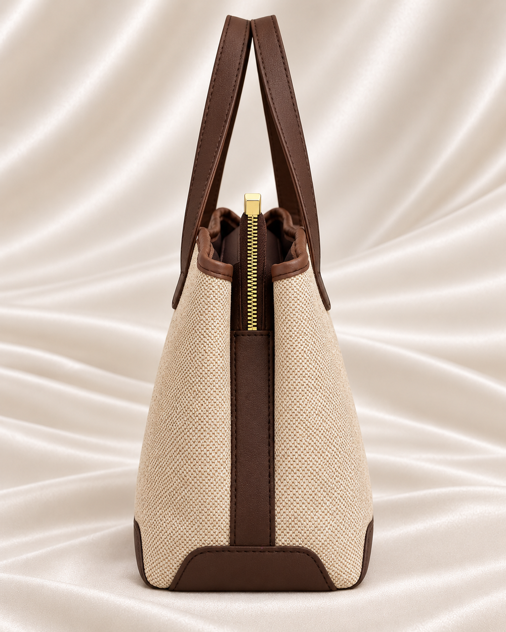 Side profile and gold zipper detail of beige and brown woven tote bag