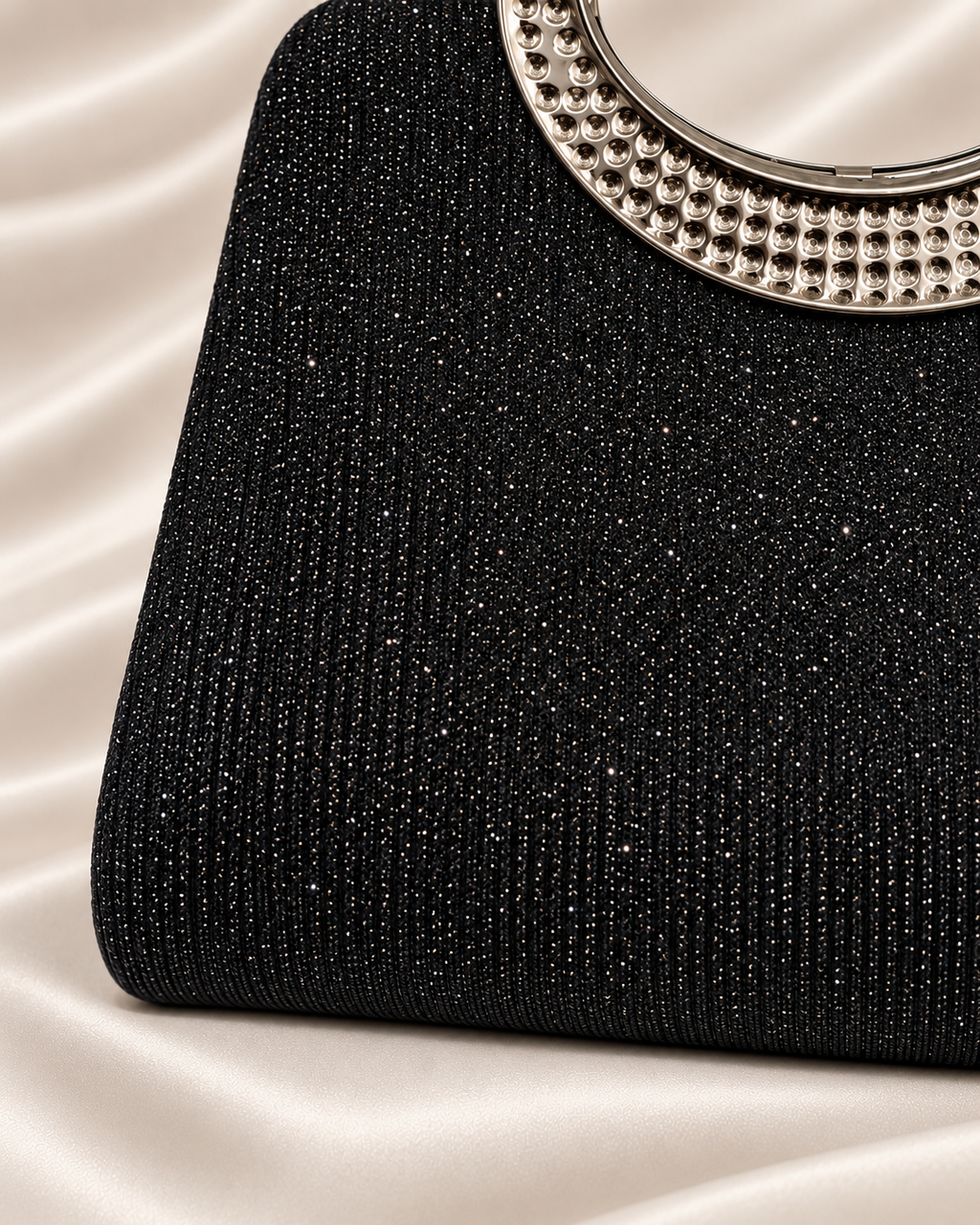Close-up of black glitter bag edge and surface detail