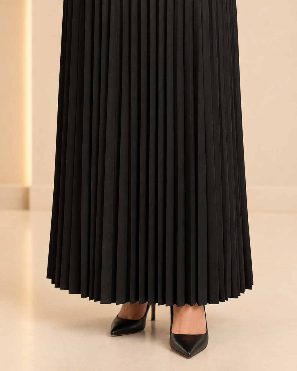 Black pleated skirt hem detail