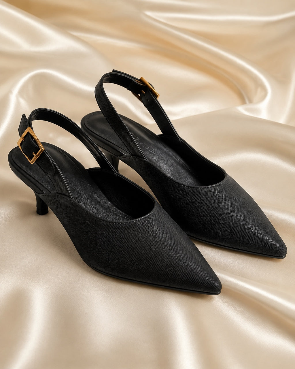 Black pointed-toe slingback heels front view