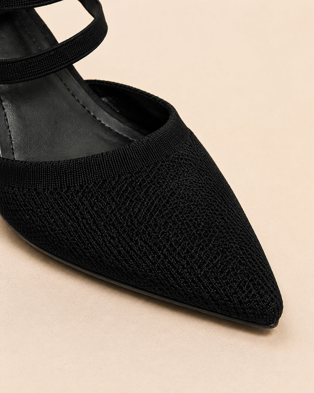 Black pointed-toe heel toe texture detail