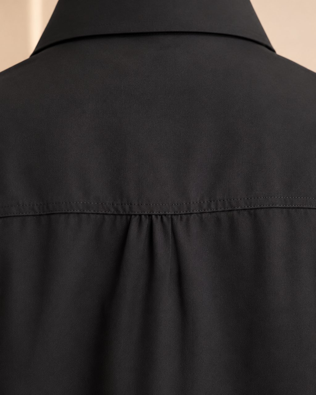 Black shirt back yoke seam and gathers detail