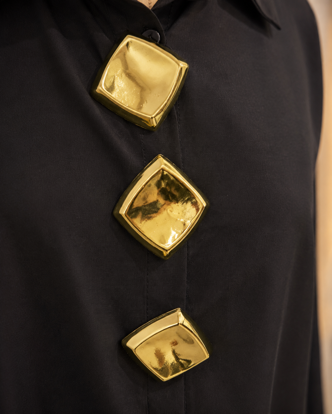 Three gold geometric accents detail