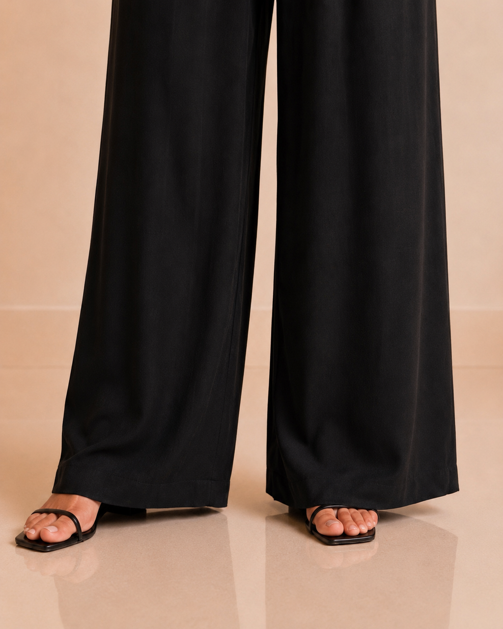 Black wide-leg pants full length and hem detail