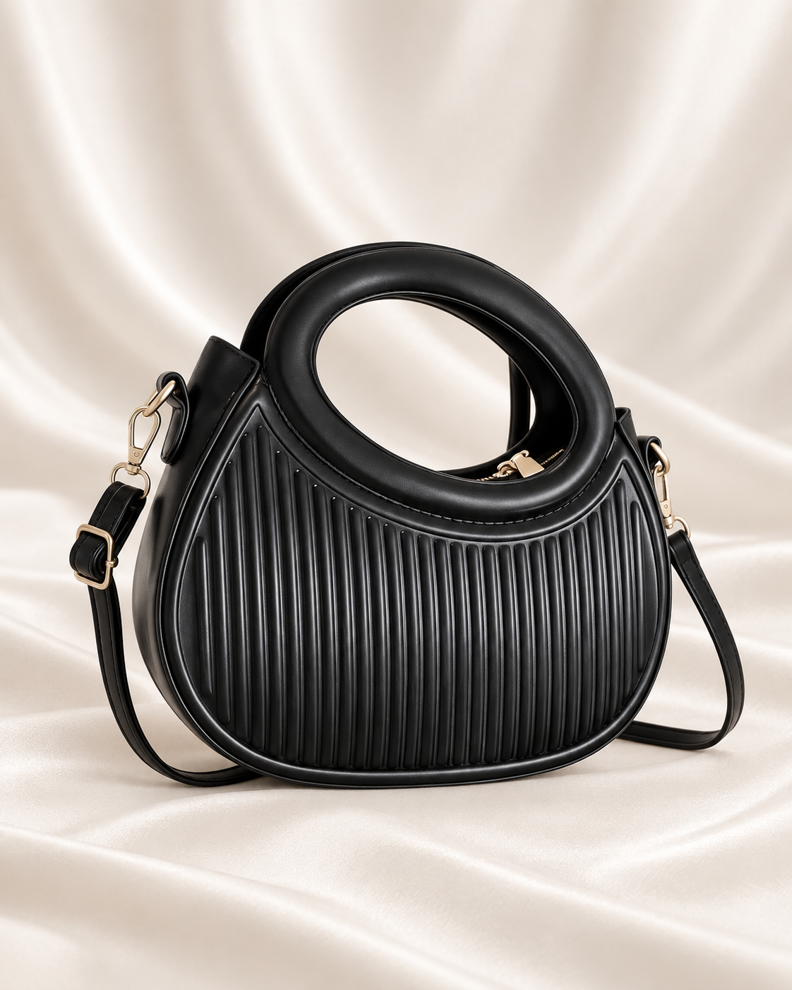 Sculpted ribbed black oval-handle crossbody bag