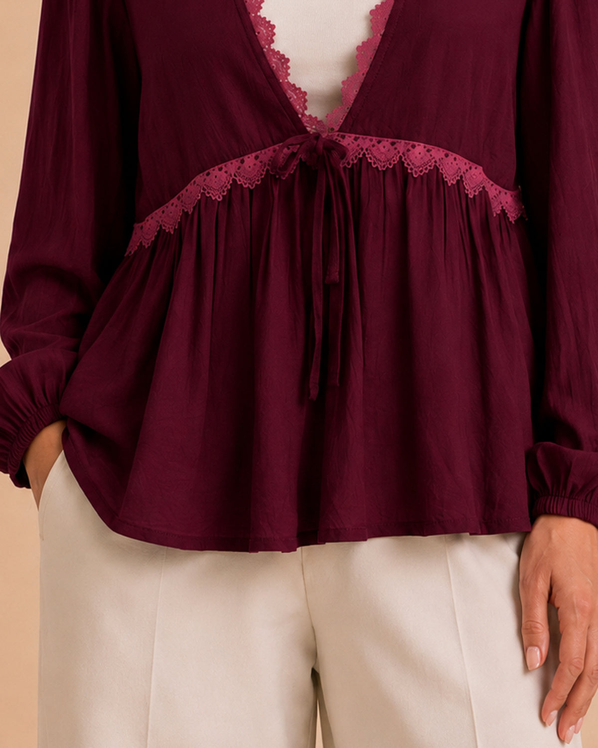 Burgundy blouse gathers and hemline detail