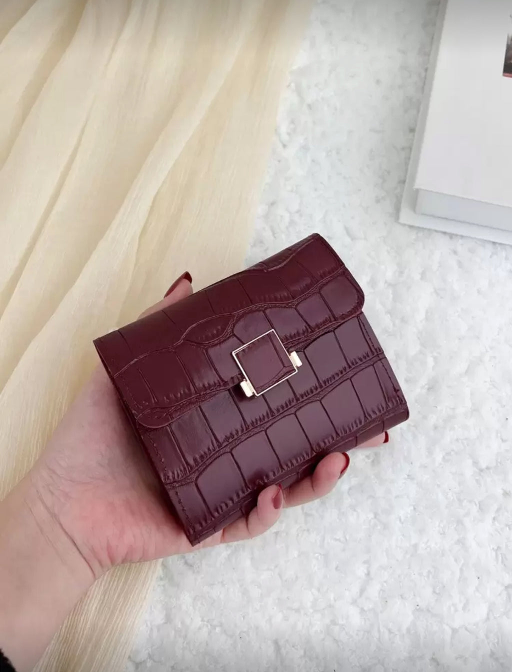 Burgundy crocodile texture compact wallet front view