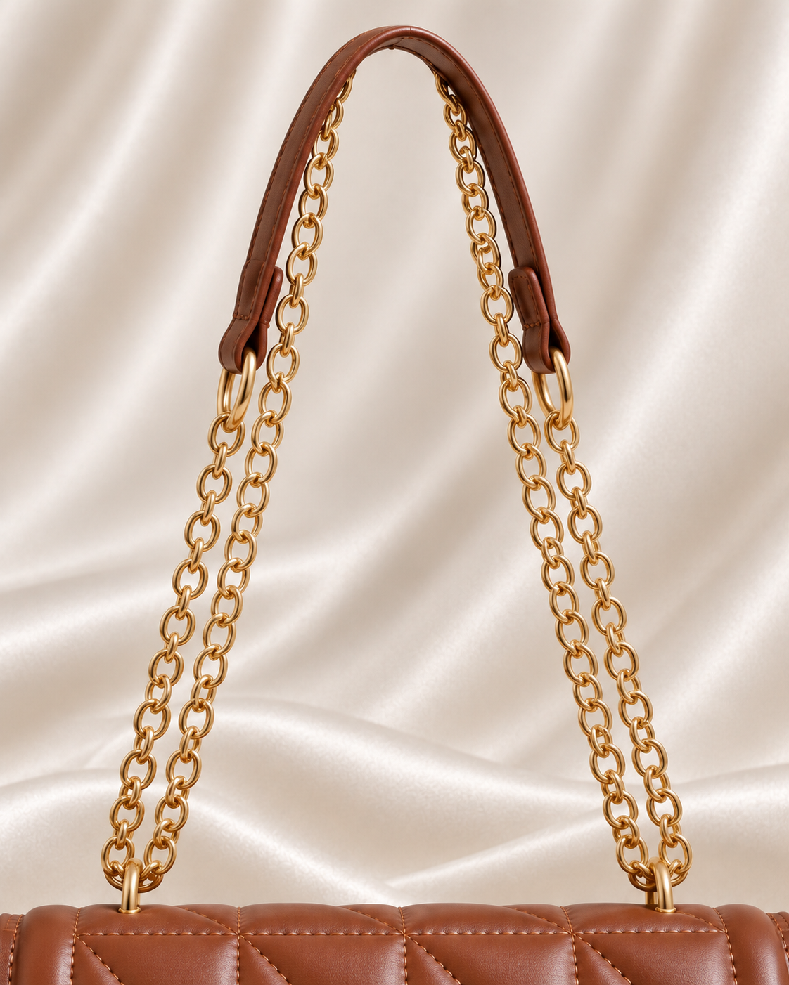 Gold chain and brown shoulder strap detail