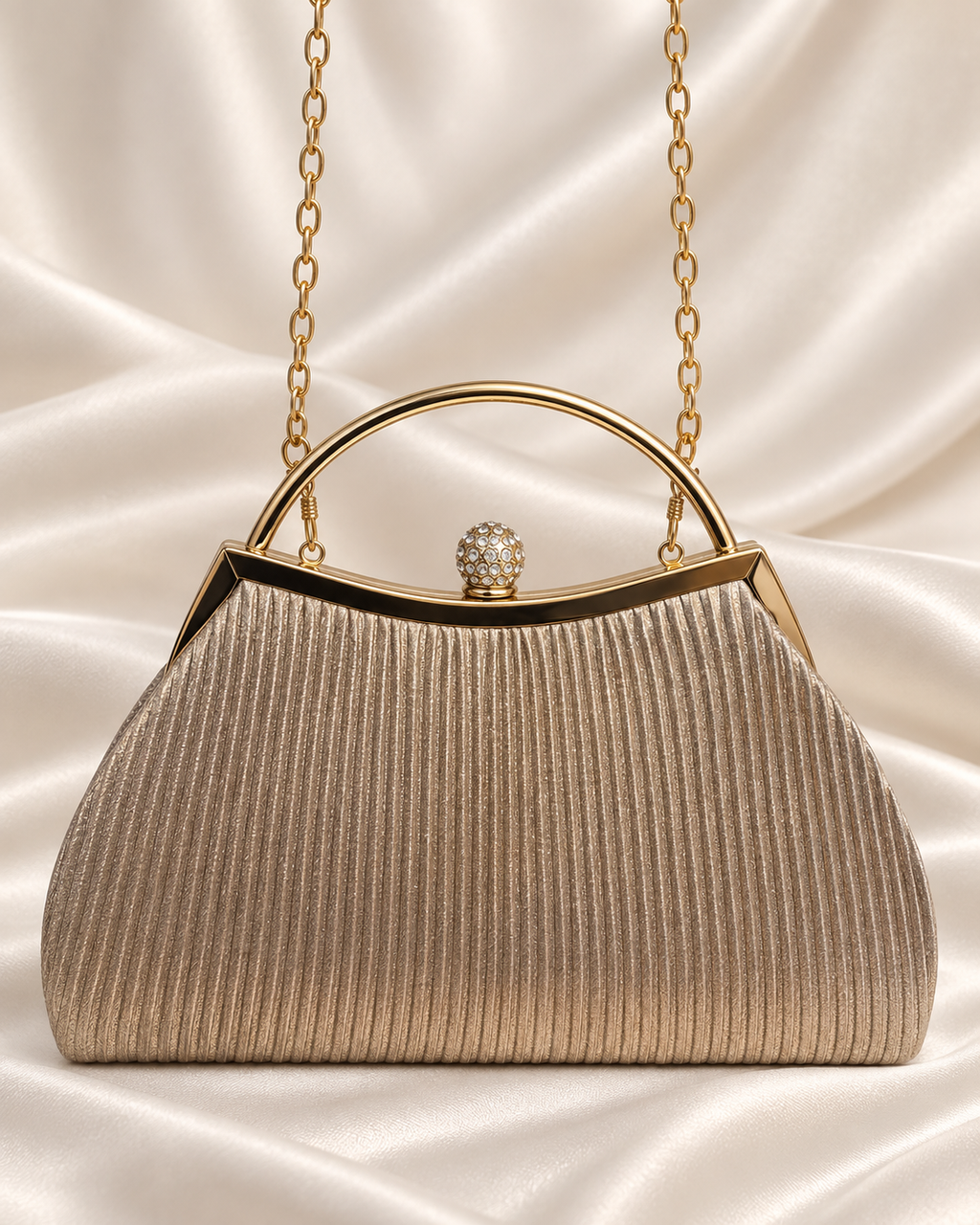 Champagne pleated evening bag with gold handle and crystal clasp