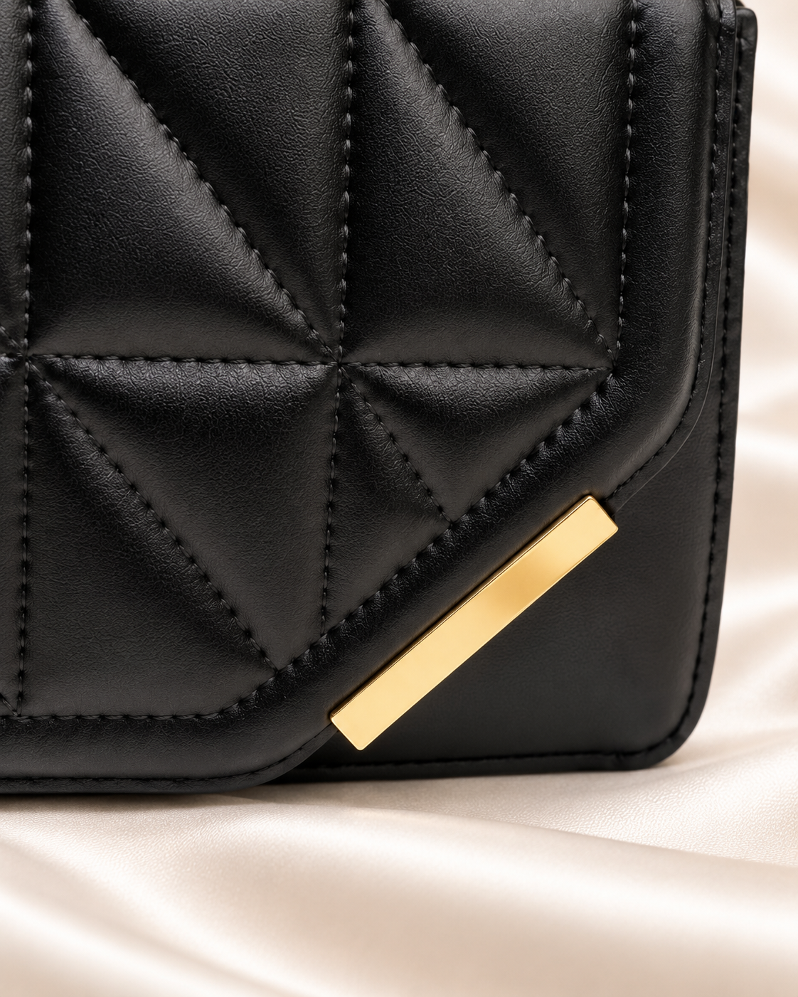 Black quilted bag gold accent detail