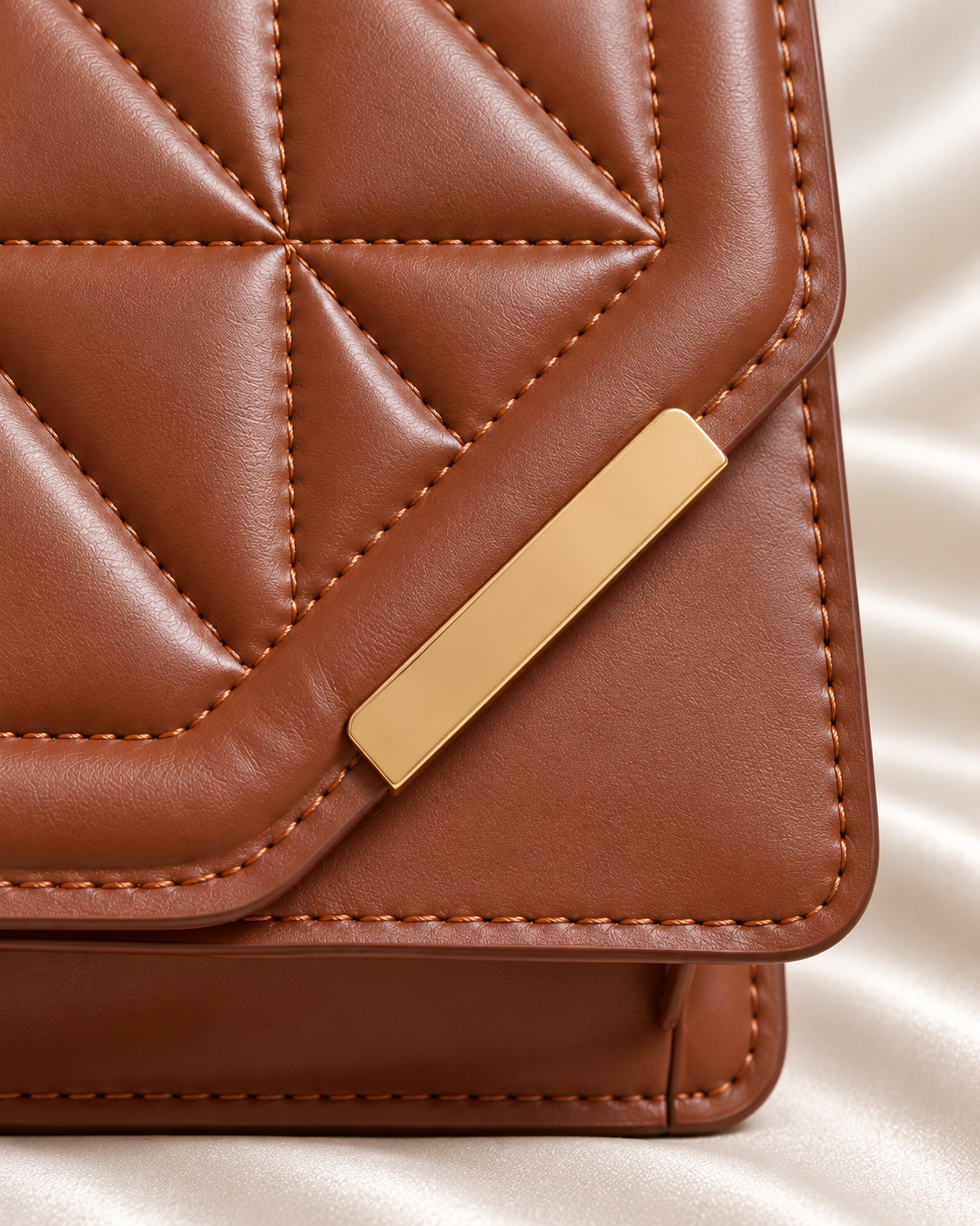 Gold-tone accent and asymmetric flap detail