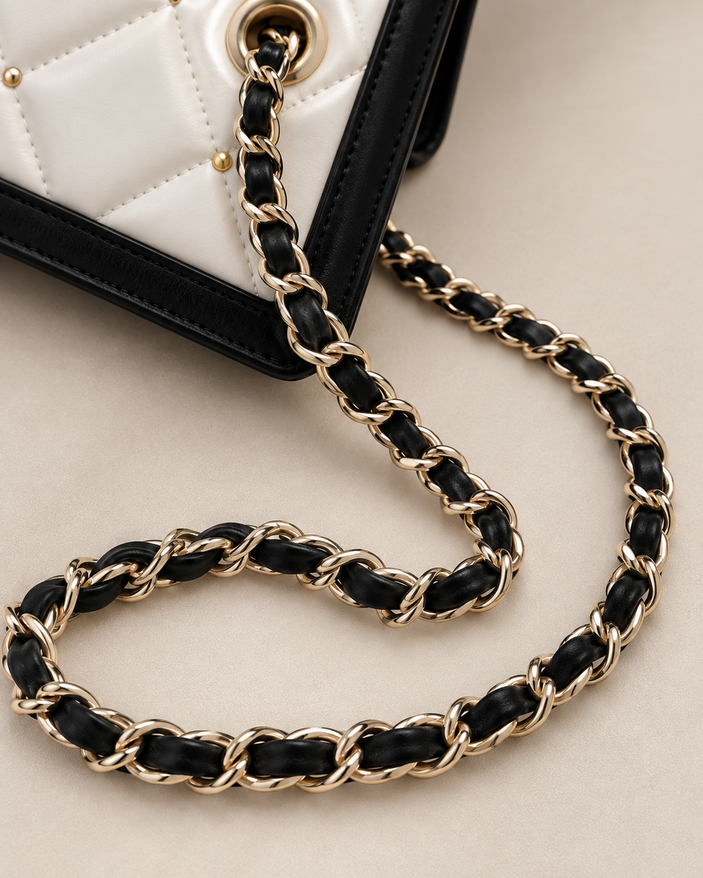 Gold and black woven chain strap detail