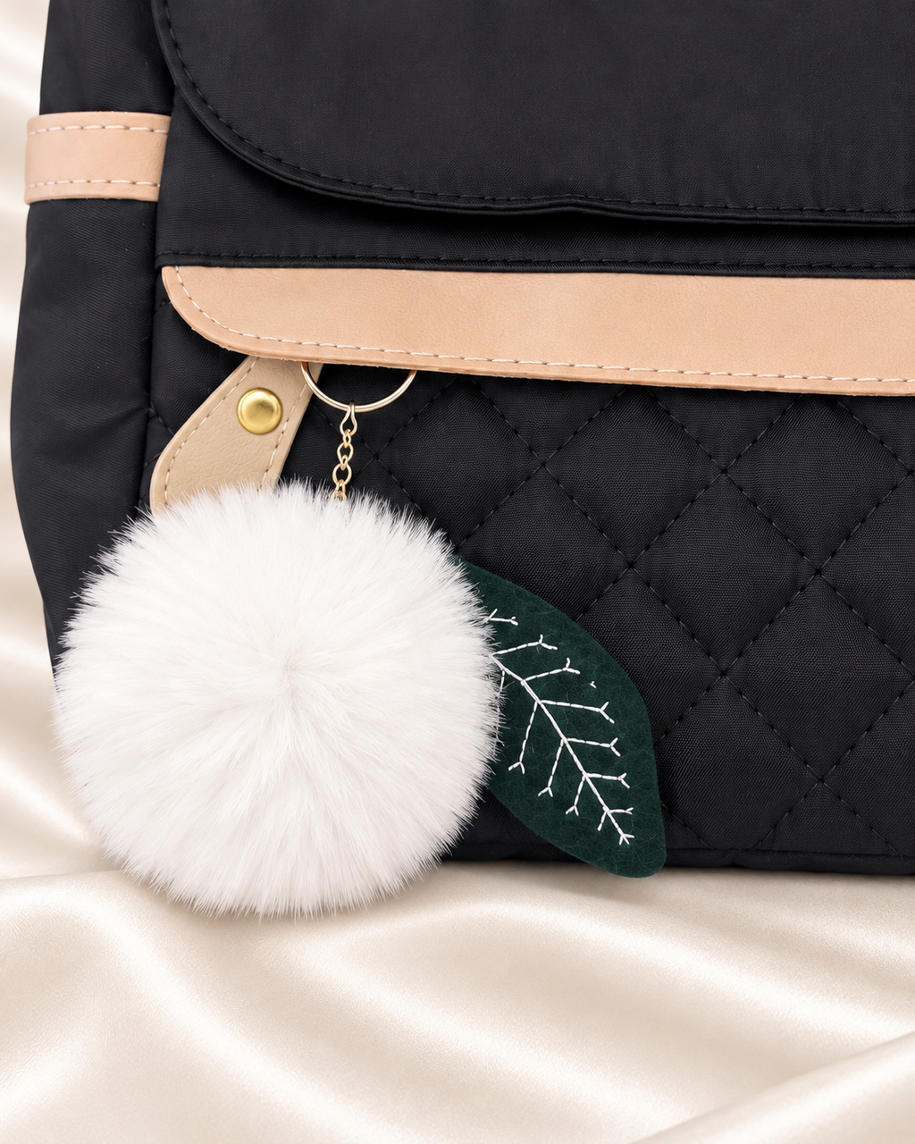 JINGPIN backpack pom pom charm and quilted front detail