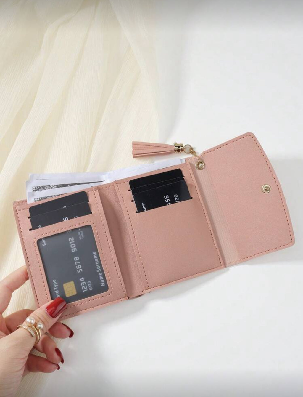 Pink compact wallet interior with card slots and ID window