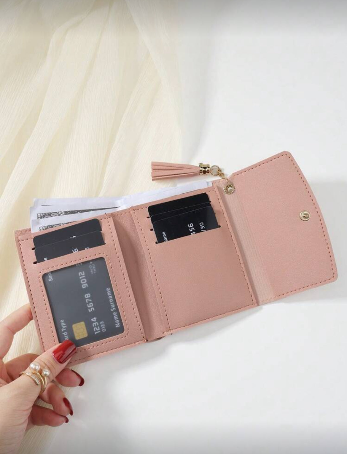 Pink compact wallet interior with card slots and ID window