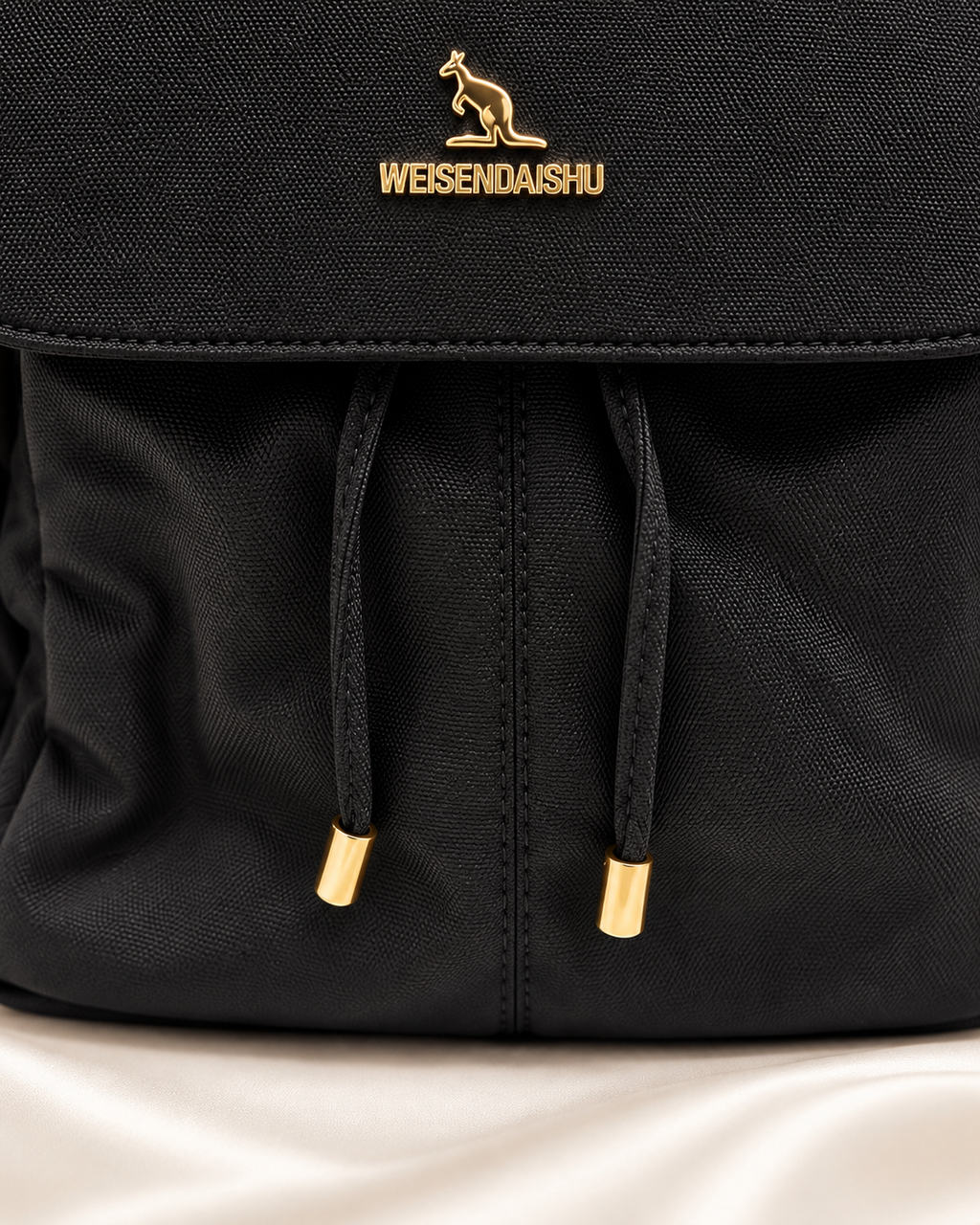 Black backpack drawstring and gold tip detail