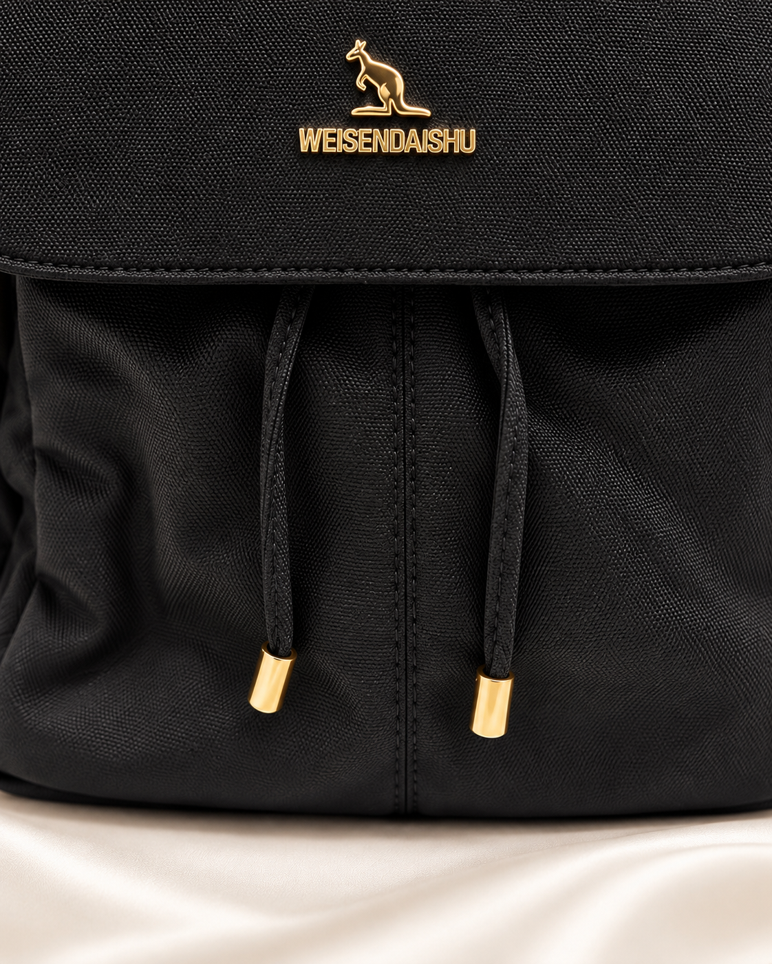 Black backpack drawstring and gold tip detail