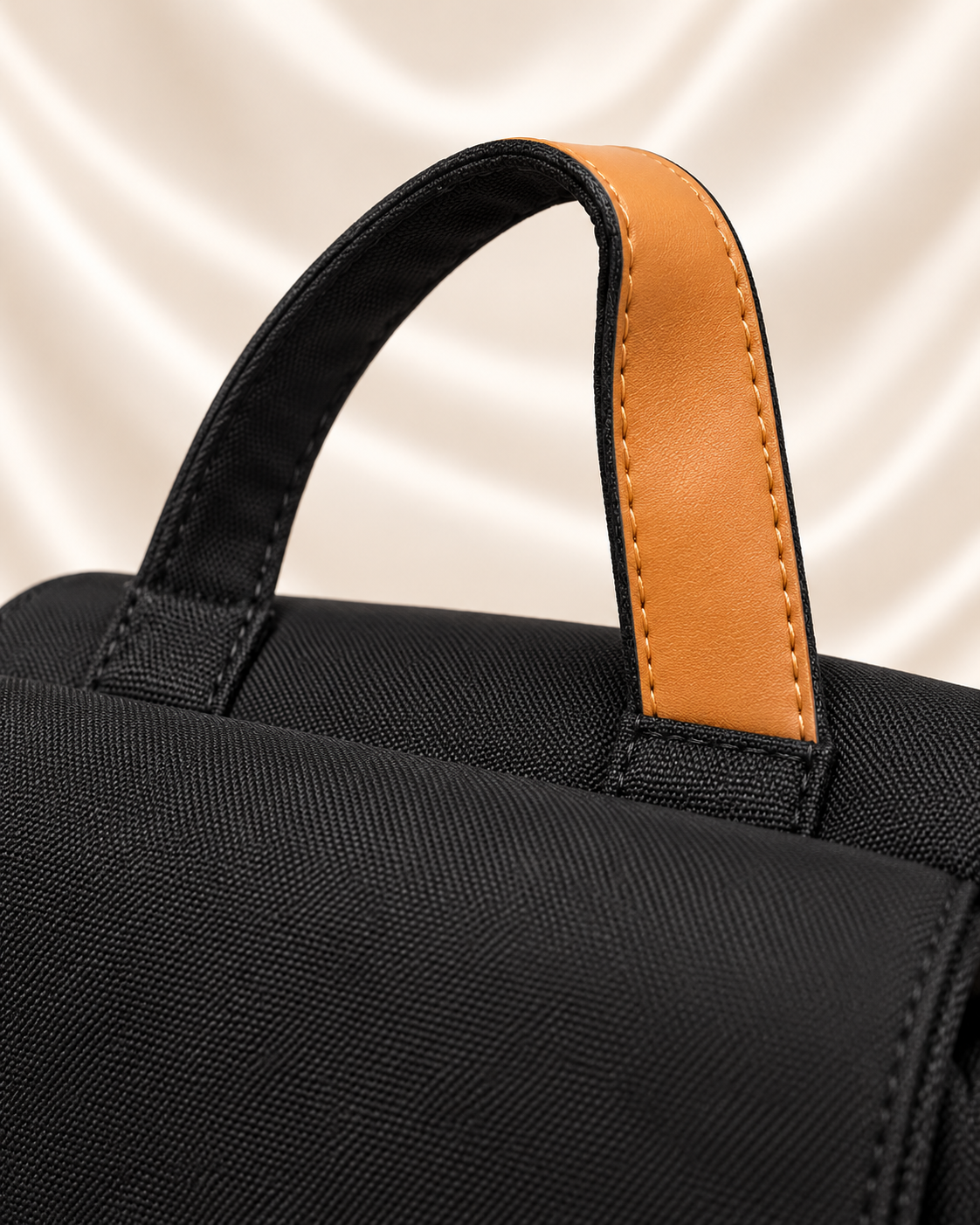 Black backpack top handle tan trim detail