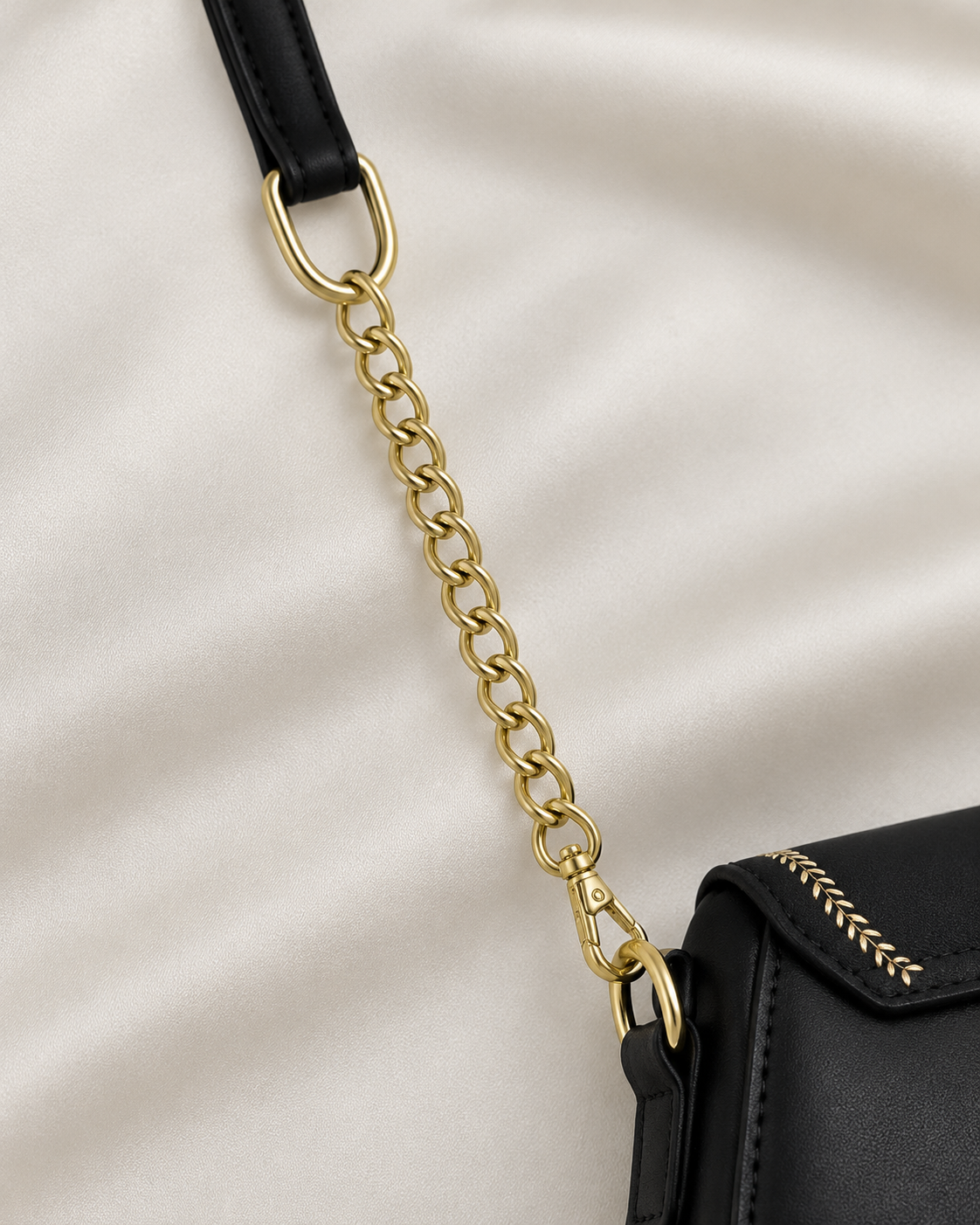 Gold chain and black shoulder strap detail