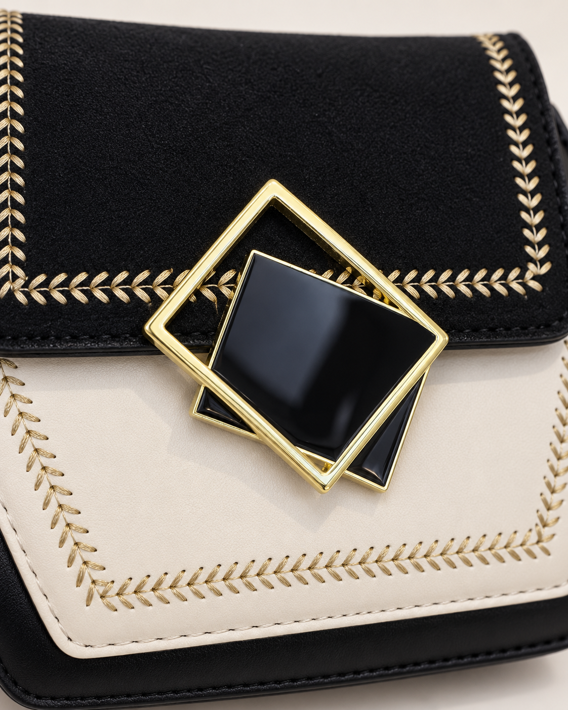 Layered black and gold geometric clasp detail