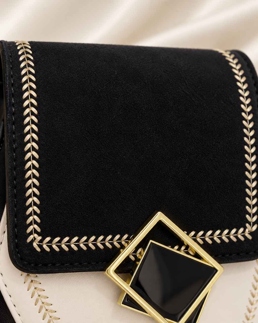 Black suede-like flap and gold embroidery detail