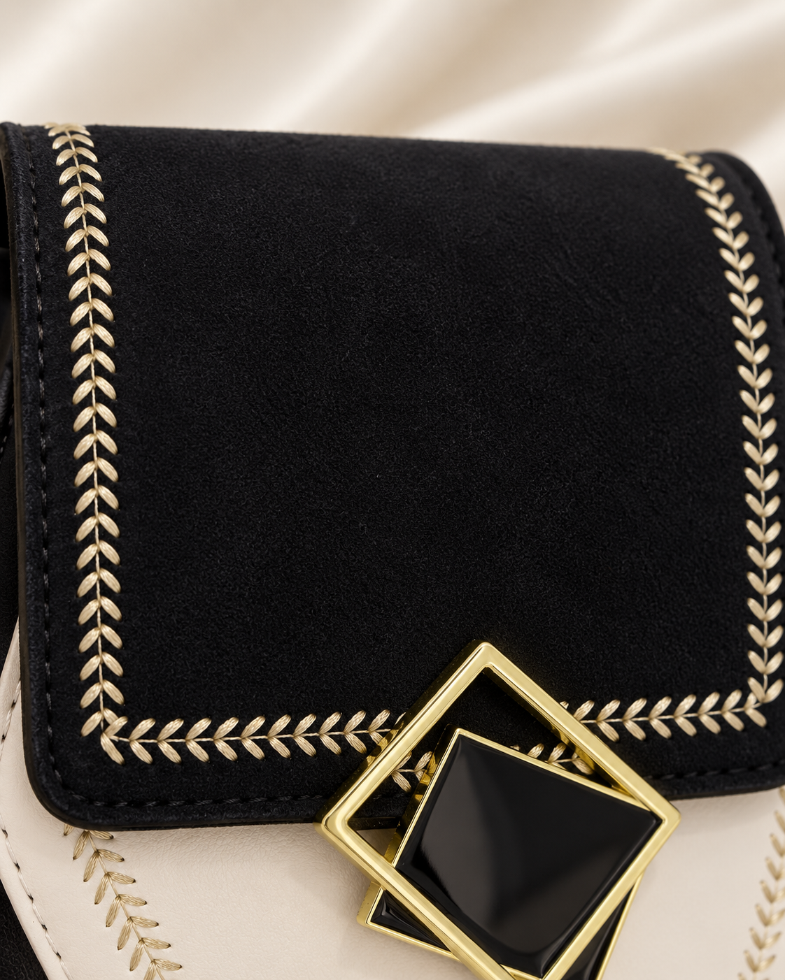 Black suede-like flap and gold embroidery detail