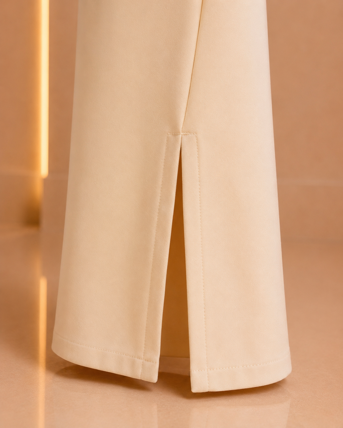 Ivory trousers leg slit and stitching close-up