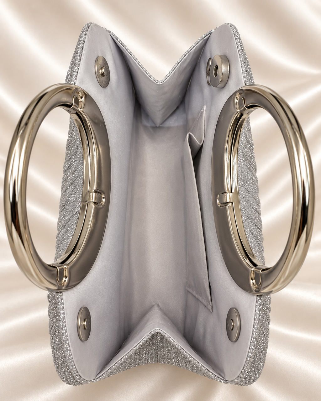 Interior and magnetic closure detail of silver glitter evening bag
