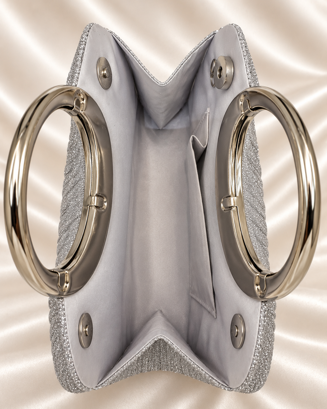 Interior and magnetic closure detail of silver glitter evening bag
