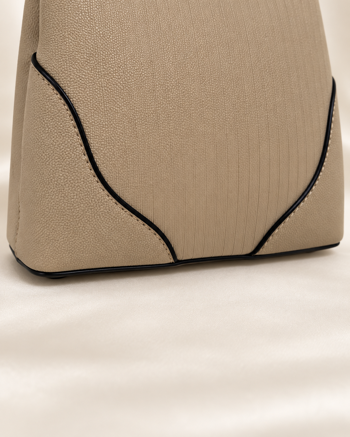 Taupe handbag base corner and piping detail