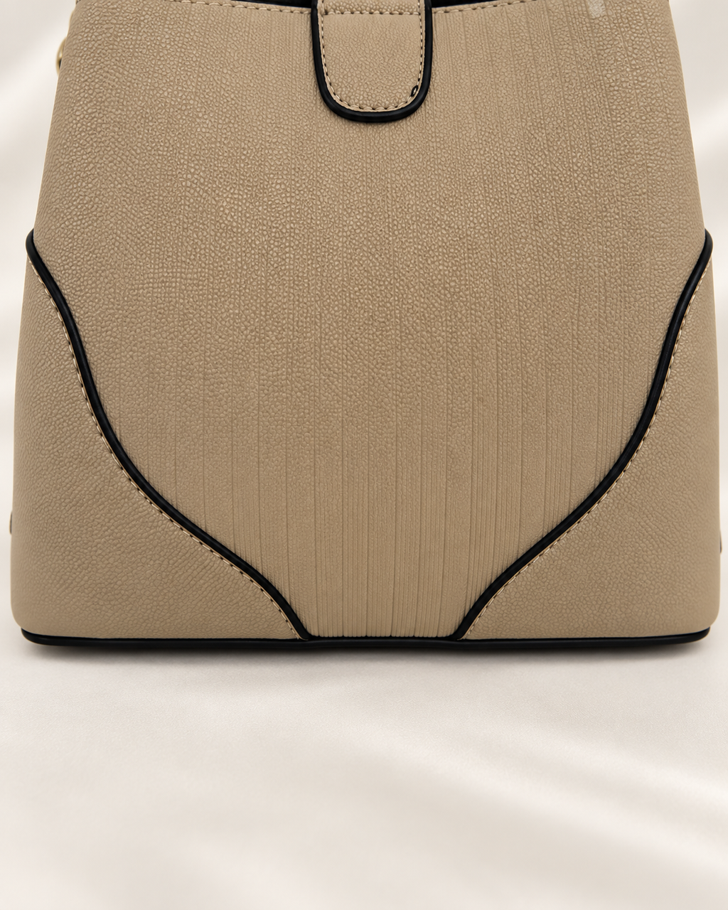 Taupe handbag black piping and panel seam detail