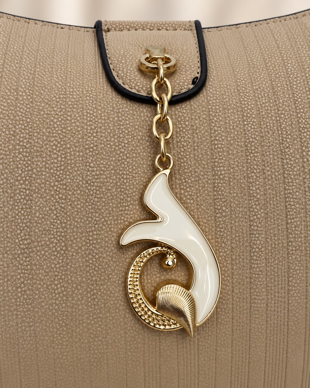 Taupe handbag gold and ivory pendant closure detail