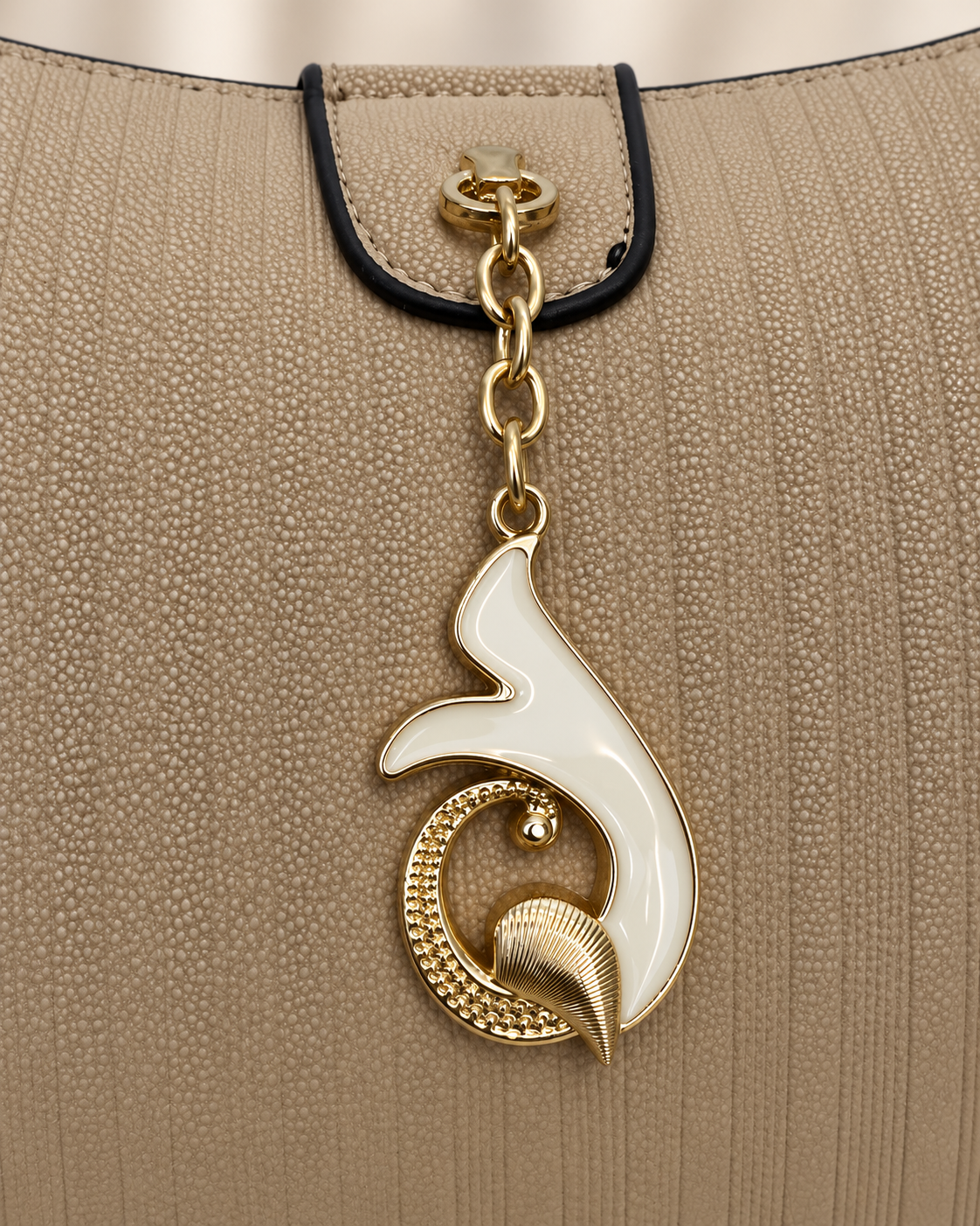 Taupe handbag gold and ivory pendant closure detail